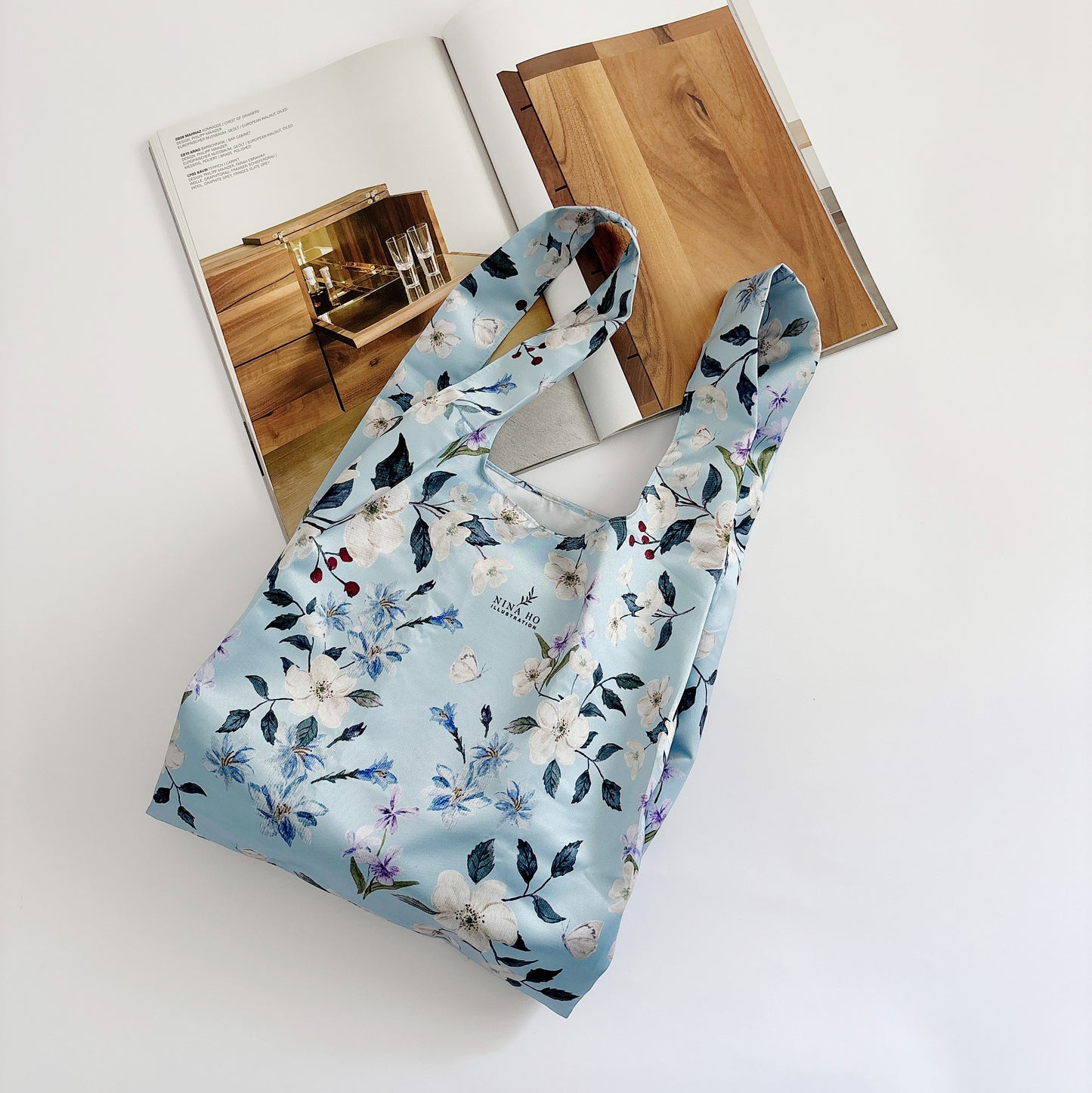 Floral wander reusable bag made from satin fabric, a lifestyle accessory that conveys everyday companionship.