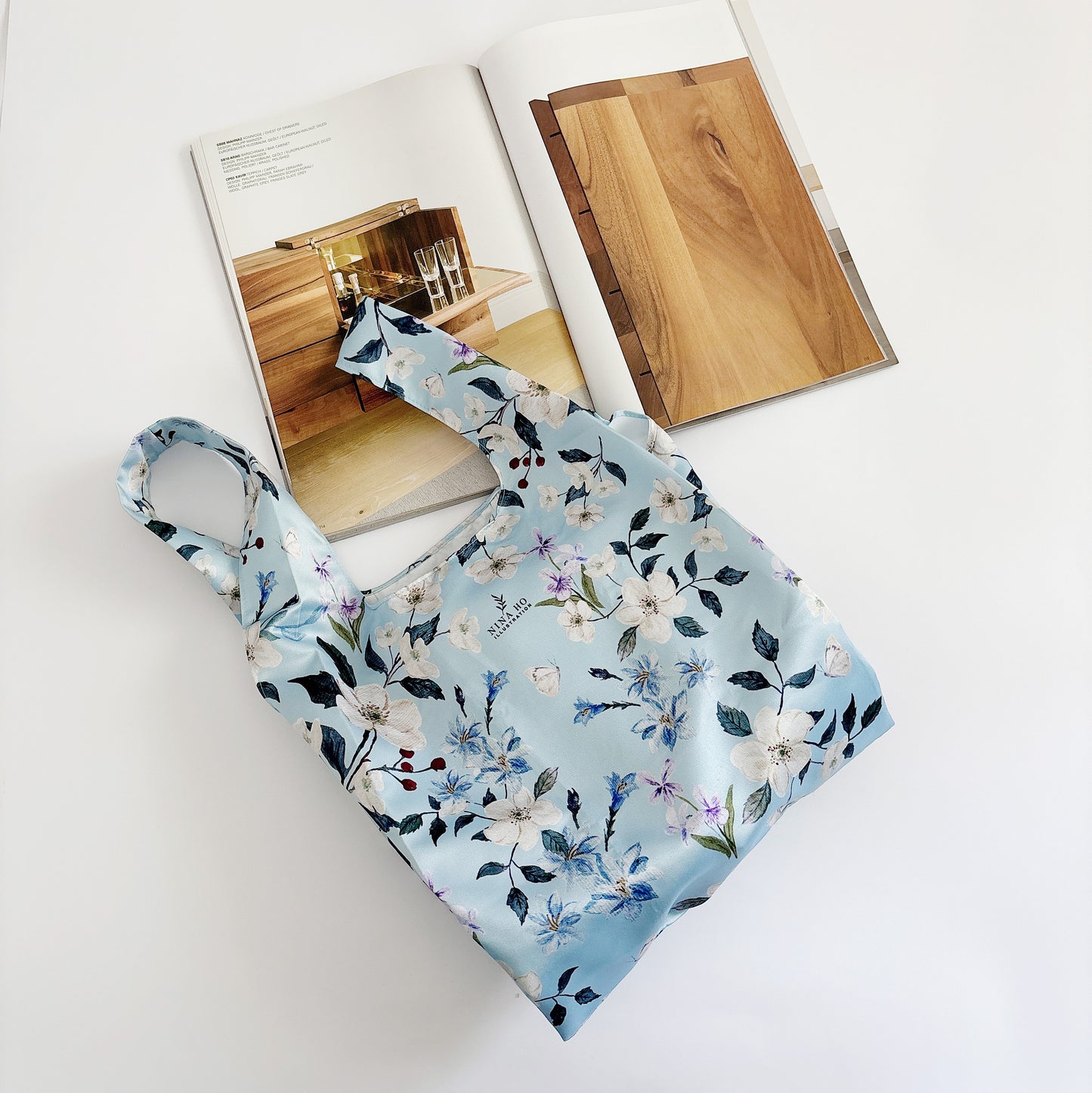 Floral wander reusable bag made from satin fabric, a lifestyle accessory that conveys everyday companionship.