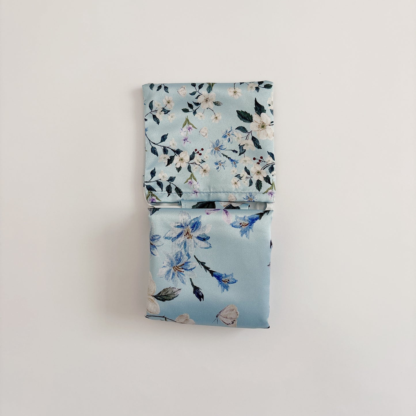 Floral wander reusable bag folded, showing folding method and watercolor floral prints.