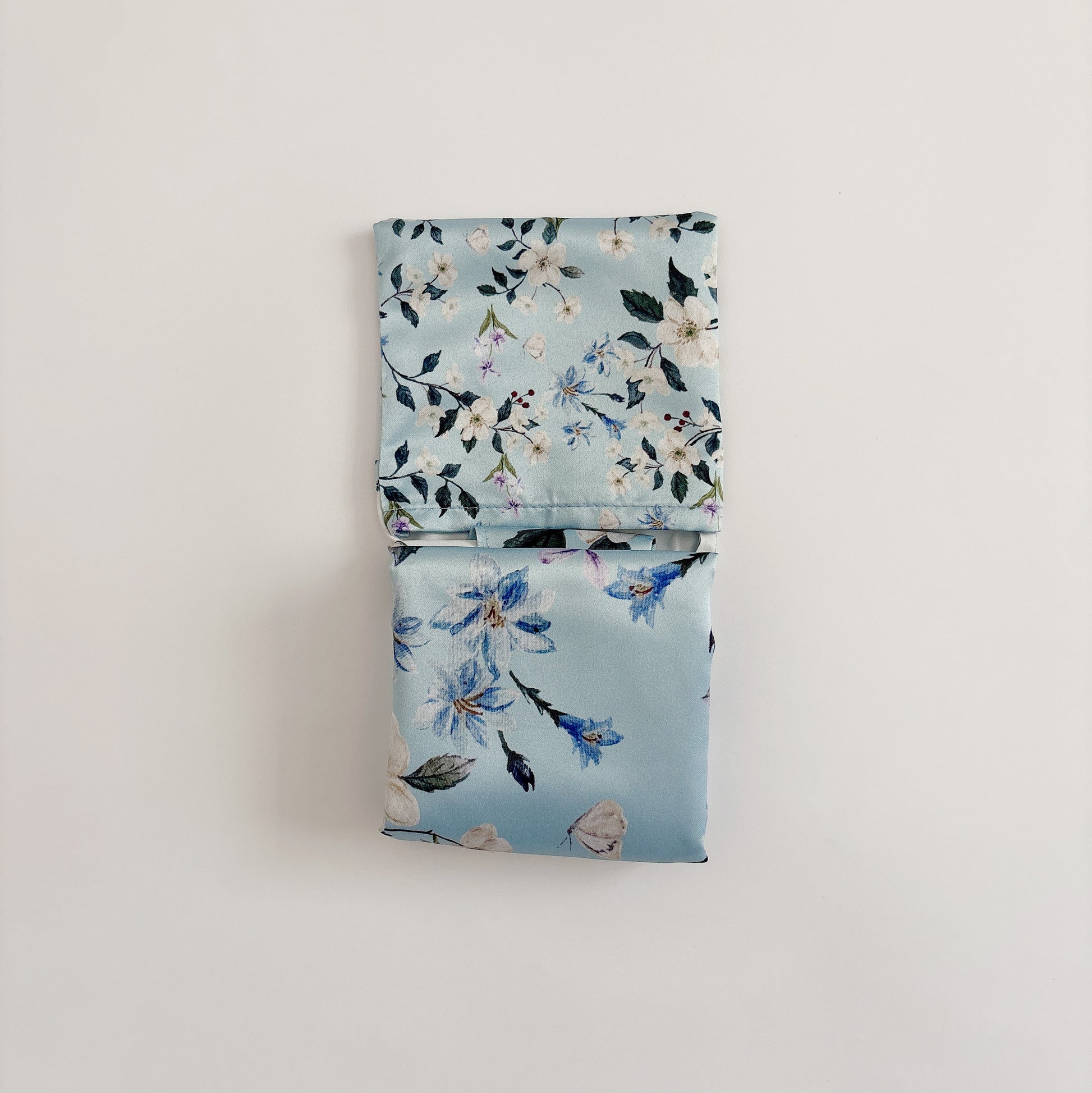 Floral wander reusable bag folded, showing folding method and watercolor floral prints.
