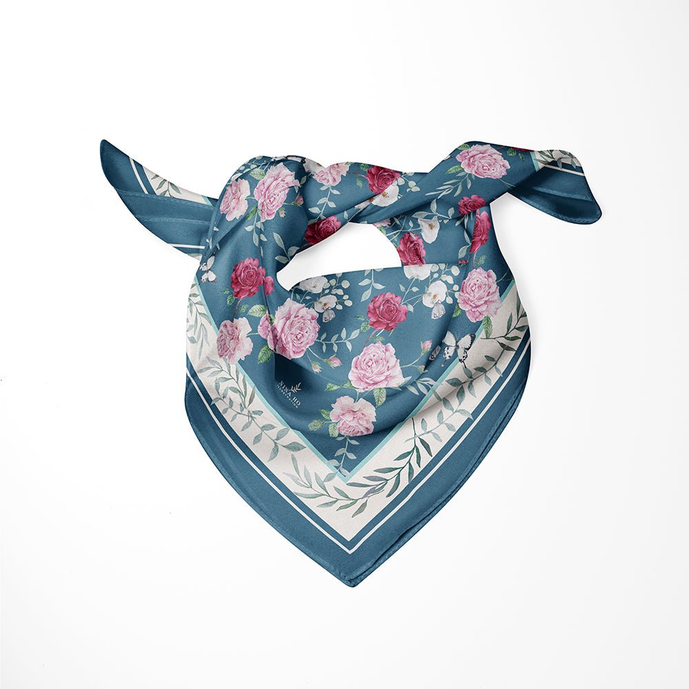 Nina Ho Illustration silk scarf featuring hand-painted pink garden roses and white blossoms on deep teal green with delicate botanical border.