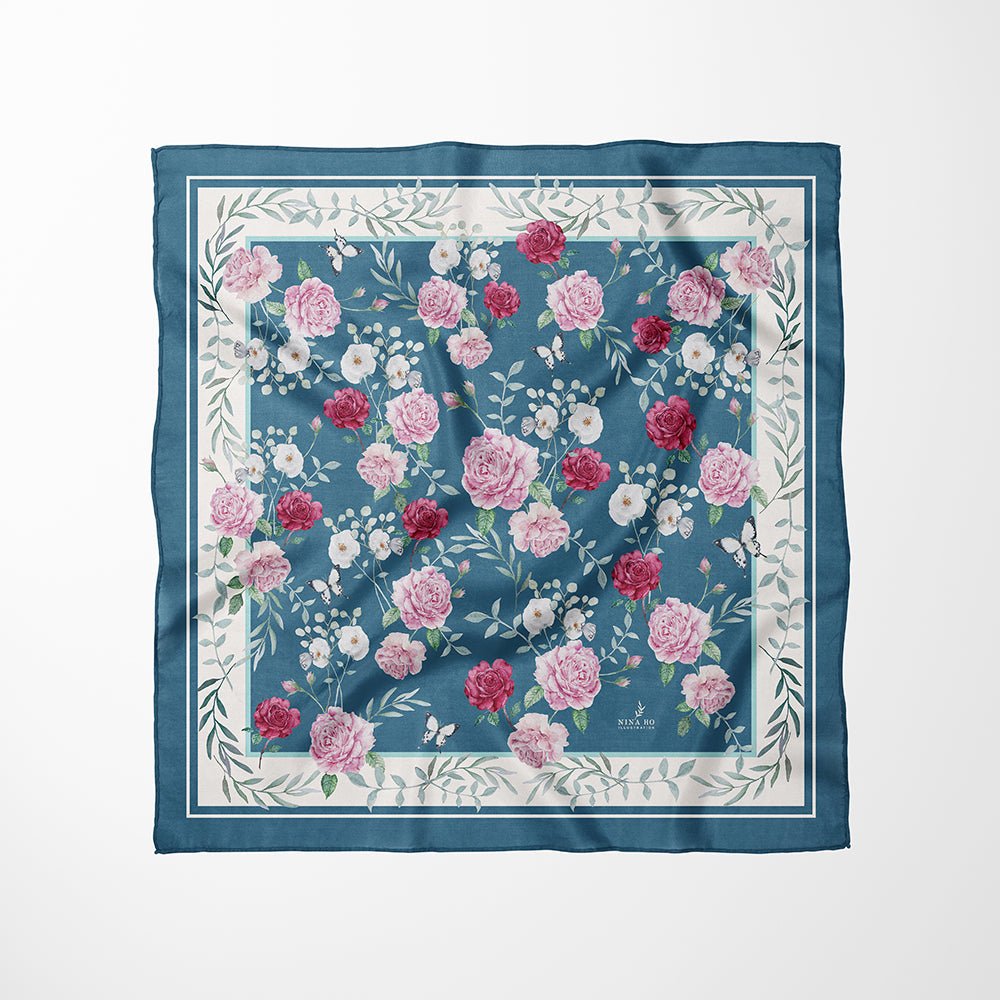 Deep teal silk scarf with hand-painted pink garden rose and white camellia and green foliage, a refined botanical keepsake by Nina Ho Illustration.