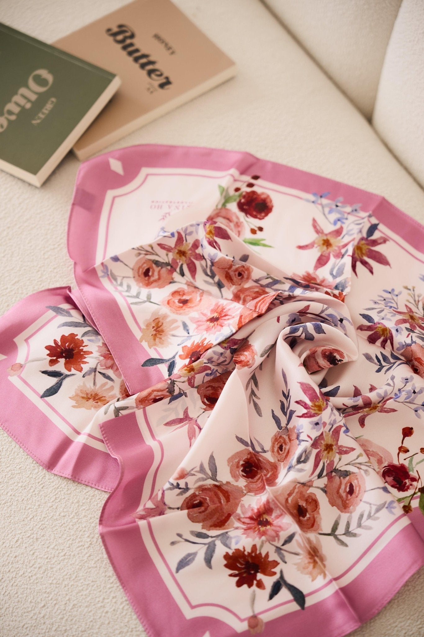 Delicate hand-painted ranunculus and purple clematis bloom in muted reds and blush on 100% mulberry silk, a refined accessory by Nina Ho Illustration.